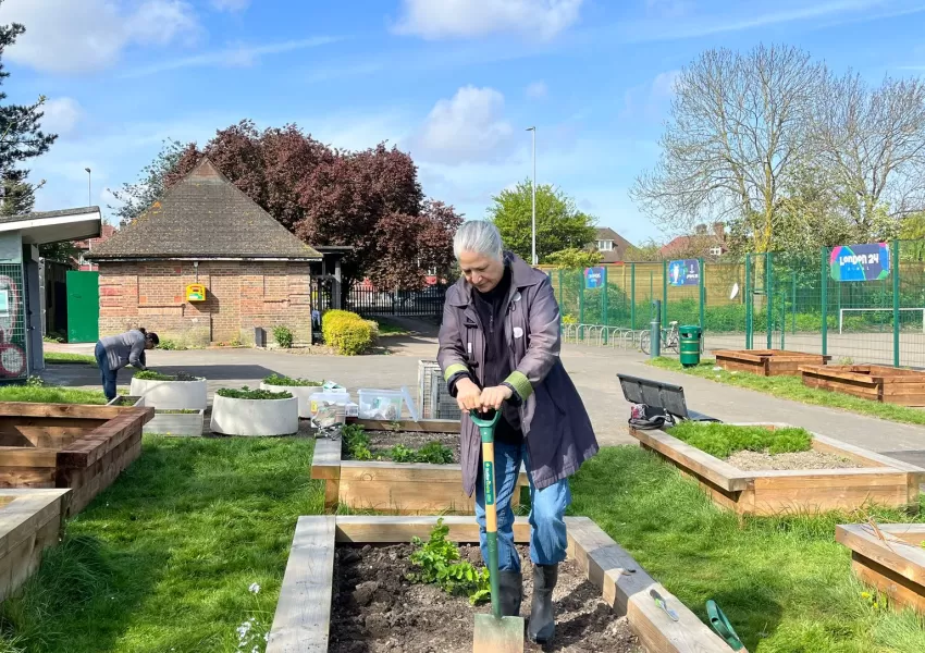 one person gardening in a park 