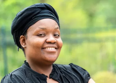 woman smiling wearing a head wrap