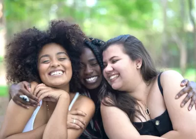 three friends laughing together