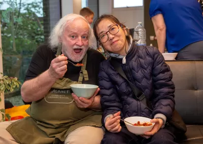 man and woman eating beans