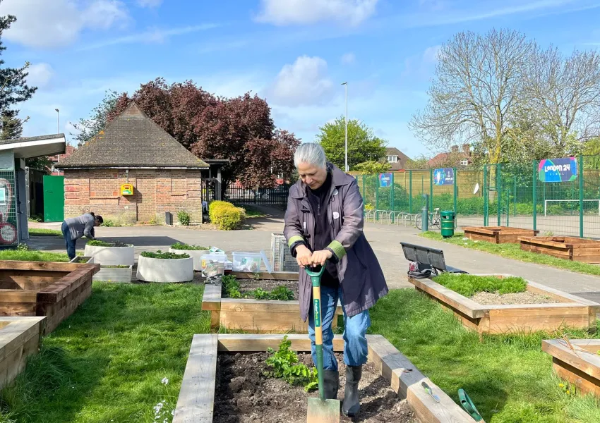 one person gardening in a park 