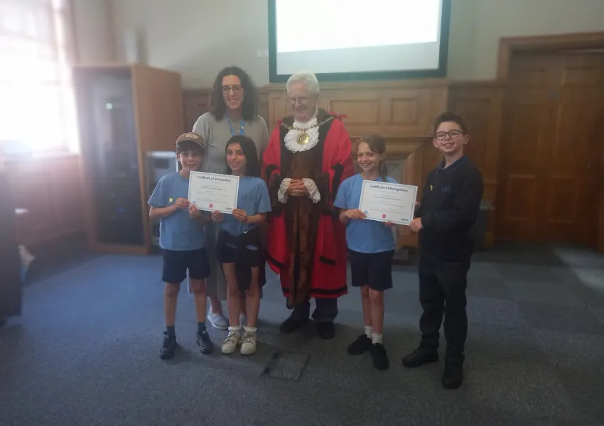 The mayor awarding certificated to children