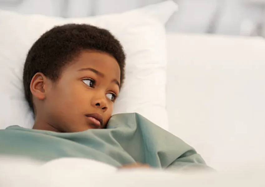 A sick child lying in bed