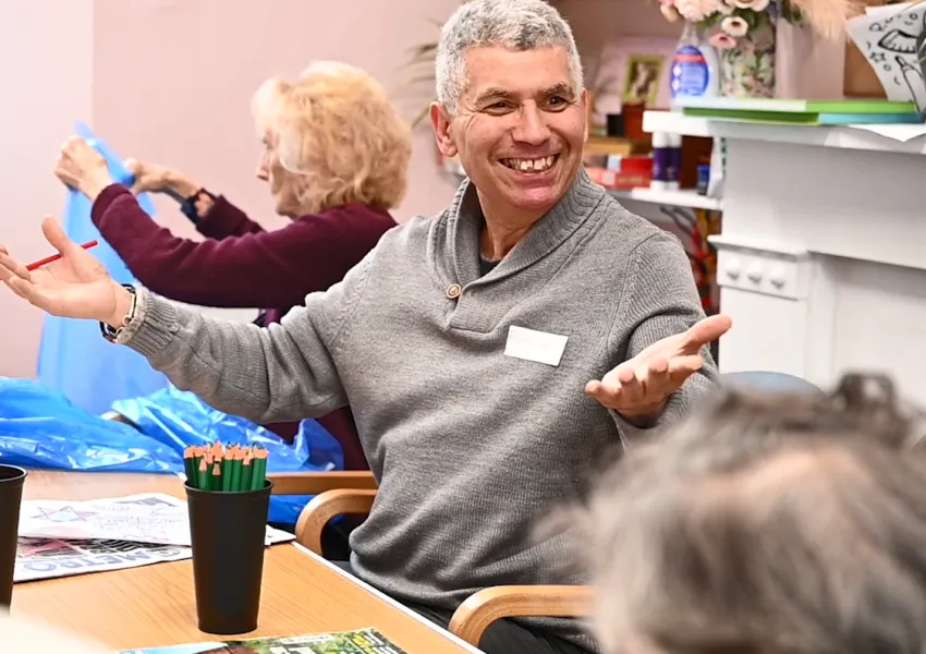Man sitting in a chair smiling.