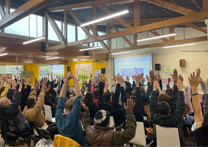 A room full of people doing chair yoga