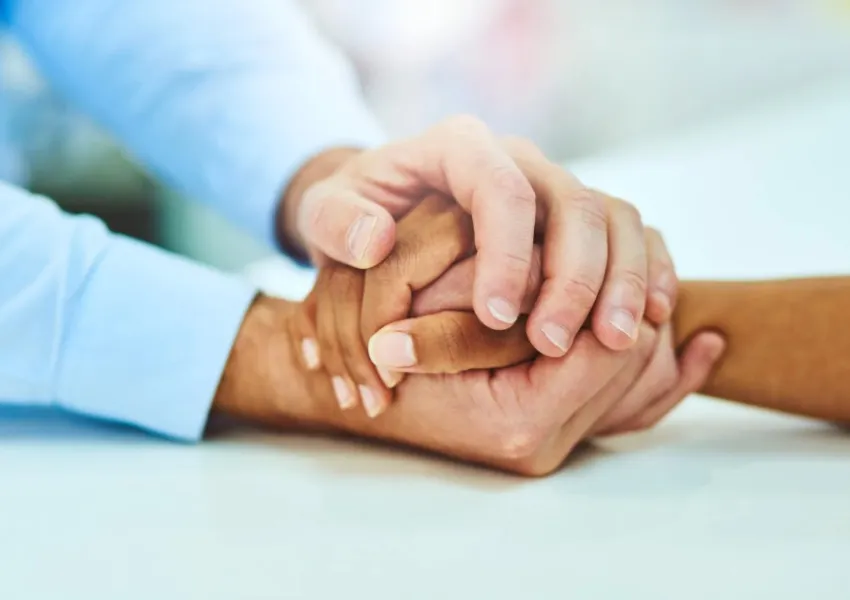 Somebody holding someone else's hand in their hands.