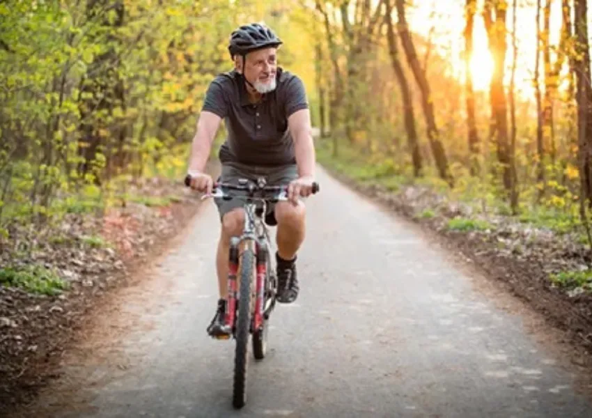 A man enjoying a bike ride in the woods