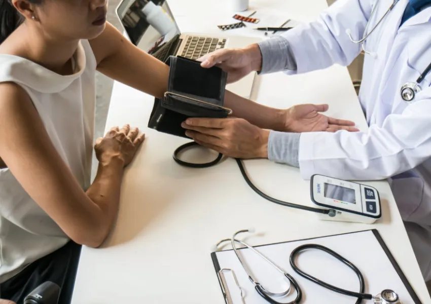 A doctor taking someone's blood pressure reading.