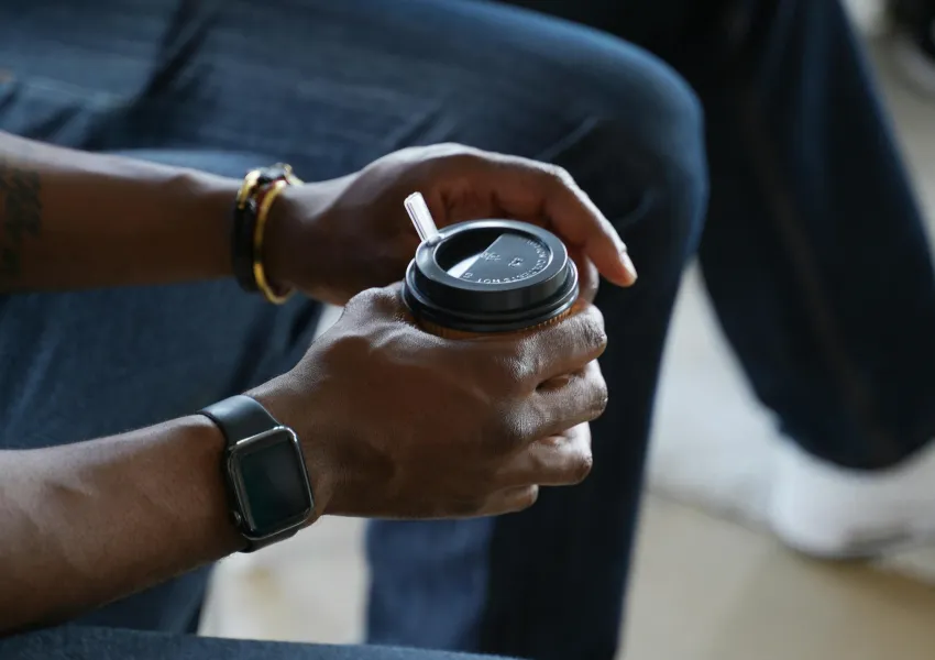 People sitting in a relaxed group setting holding coffee cups