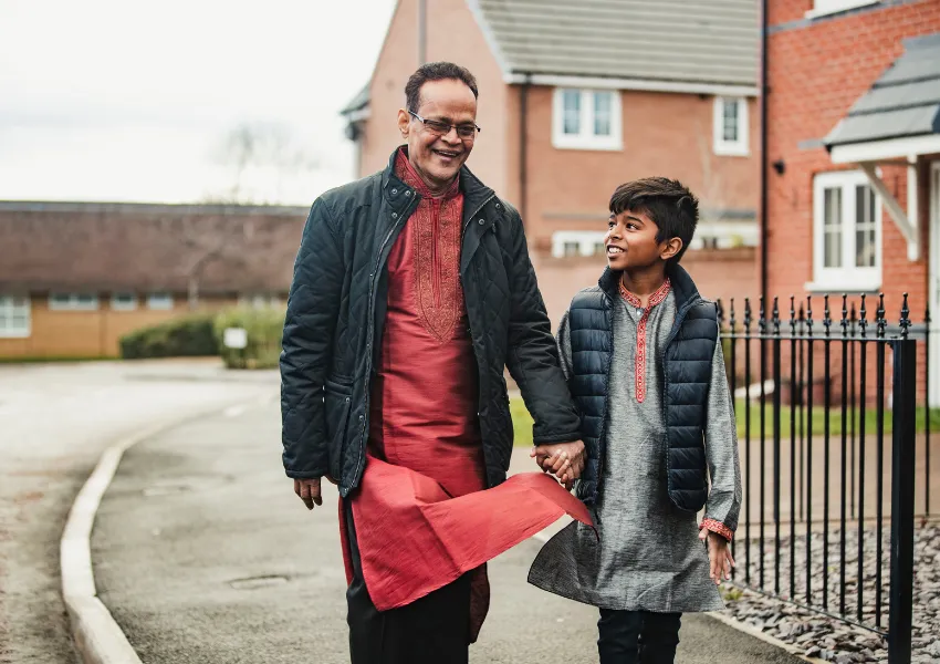 Father and son walking to school