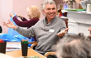 Man sitting in a chair smiling.