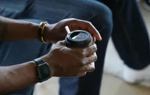People sitting in a relaxed group setting holding coffee cups