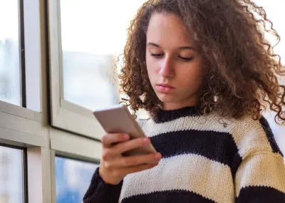 Young teenager looking at her phone