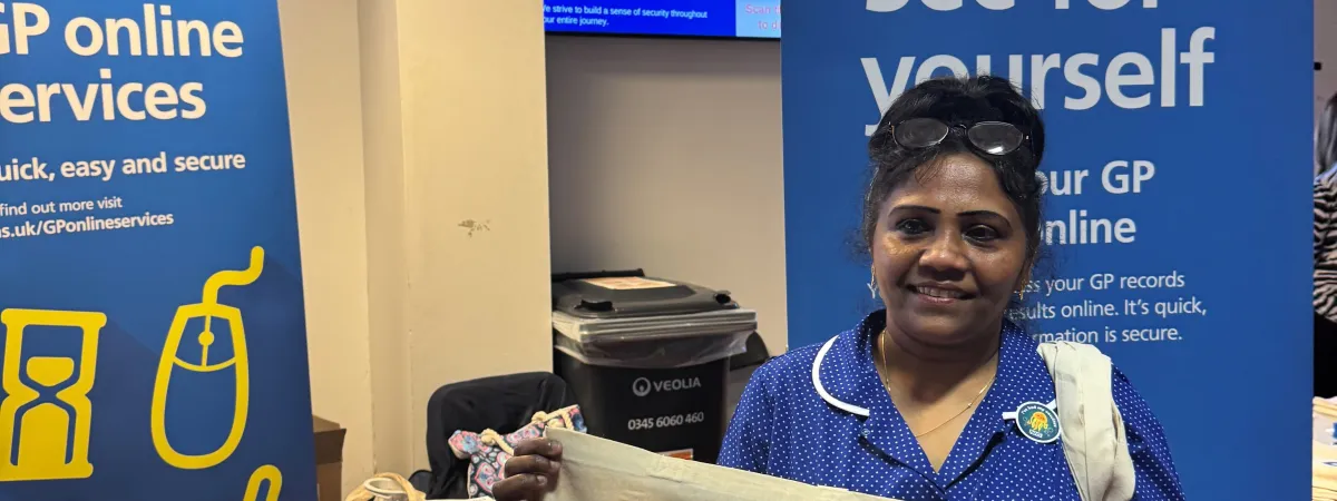 Person holding a totebag promoting vaccine information.
