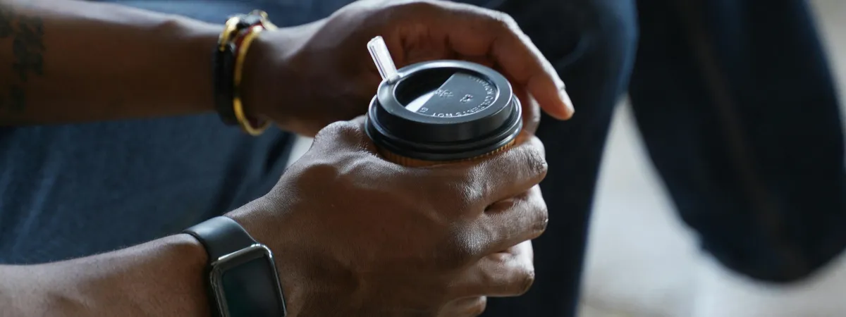 People sitting in a relaxed group setting holding coffee cups