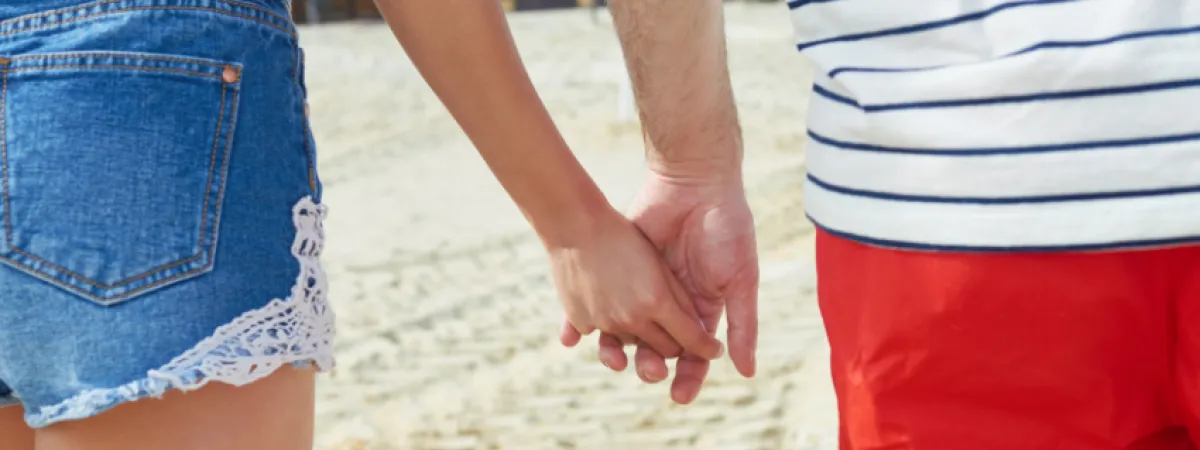 A couple on holiday holding hands